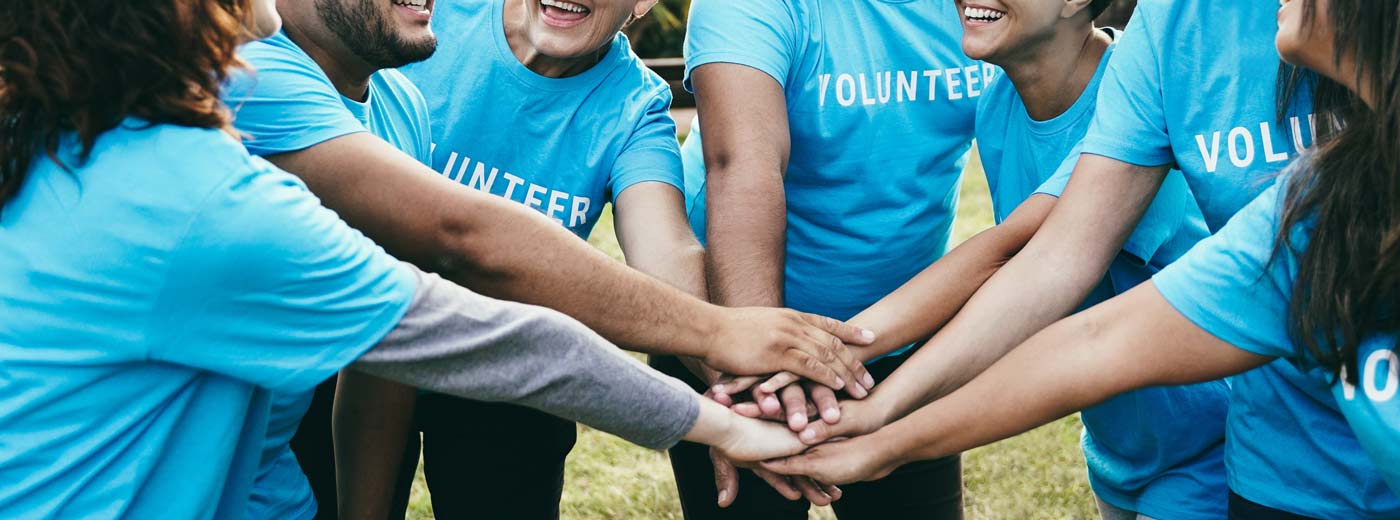 Volunteers with hands in center