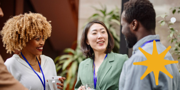 A group of conference attendees talking before a session.